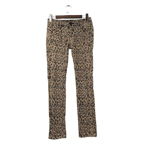 May include: Brown leopard print skinny jeans with a dark brown waistband.