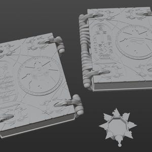 May include: Three gray 3D printed models of a book with intricate designs and a star-shaped object. The book has a detailed design with a circular pattern and text on the cover.