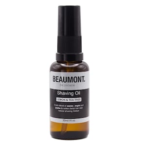 May include: A brown glass bottle with a black spray top containing a lemon and tea tree shaving oil. The bottle is labelled "BEAUMONT. Skincare Shaving Oil LEMON & TEA TREE" and "30ml/1fl oz".