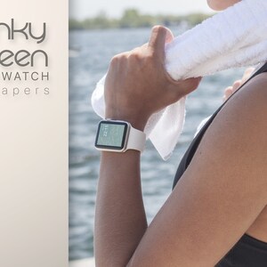 May include: A silver smartwatch with a white band is worn on a wrist. The watch displays a digital clock. The words "Funky Screen SMARTWATCH wallpapers" are in the upper left corner. A white towel rests on the person's shoulder.