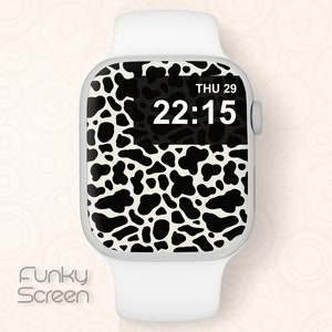 May include: A white Apple Watch with a black and white cow print watch face. The time is 22:15 and the date is THU 29.