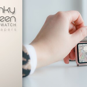 May include: A rose gold smartwatch with a colorful abstract design on the screen. The time is 22:15. The watch is on a white surface.