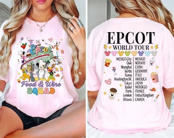 May include: A light pink t-shirt featuring the text "Epcot Food & Wine Squad" with cartoon characters. The back of the shirt has "Epcot World Tour" text and a list of cities. The shirt is a casual style.