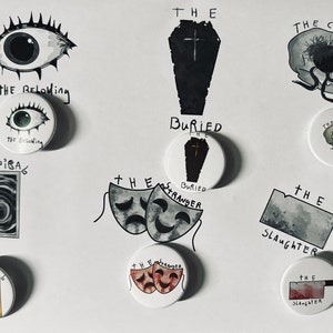May include: Nine white round buttons with black and white illustrations. The buttons feature various images, including an eye, a coffin, a skull, a door, a mask, and a knife. The text on the buttons includes "The Following", "The Corruption", "The Spiral", "The Stranger", "The Slaughter", and "Buried".