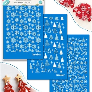 May include: A polymer clay kit with blue stencils featuring snowflake, Christmas tree, and holiday ornament designs. Two red Christmas tree earrings with gold star toppers are also shown. The kit includes the text "keoker" and "Polymer Clay Kit".