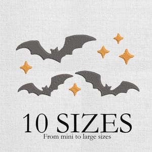 May include: Embroidered design with two grey bats and four gold stars on a white background. The text "10 SIZES" is displayed below the design, with the phrase "From mini to large sizes" underneath.