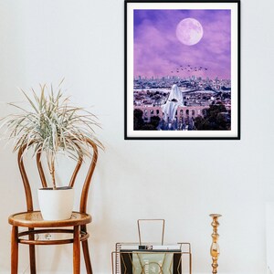 May include: A digital art print featuring a white ghost figure sitting on a rooftop overlooking a city skyline. The sky is a vibrant purple with a large, full moon.