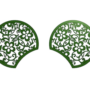 May include: Two green, decorative, half-circle cutouts with a floral design. The cutouts are symmetrical and have a white background.