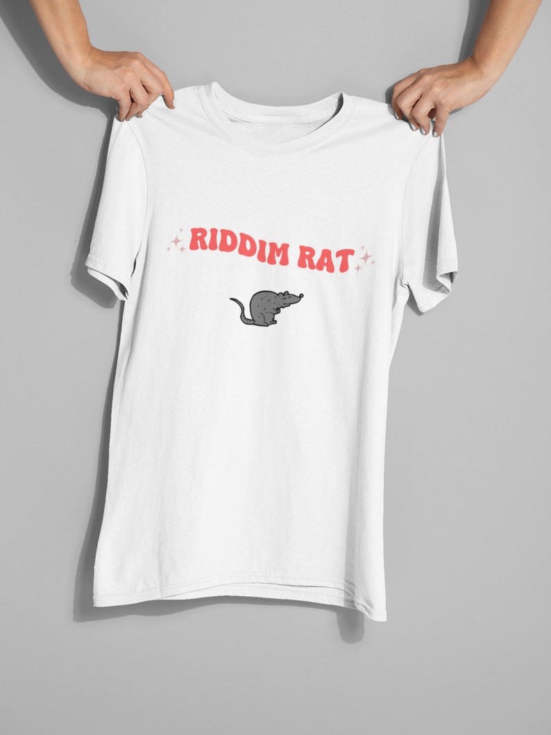 May include: White t-shirt with a red graphic that says "RIDDIM RAT" and a cartoon rat illustration.