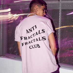 May include: A light pink t-shirt with black text that reads "ANTI FRACTALS FRACTALS CLUB".