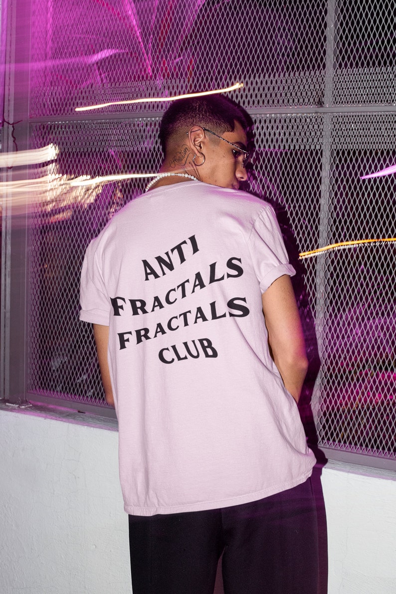 May include: A light pink t-shirt with black text that reads "ANTI FRACTALS FRACTALS CLUB".