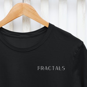 May include: Black t-shirt with the word "FRACTALS" printed in white on the front.