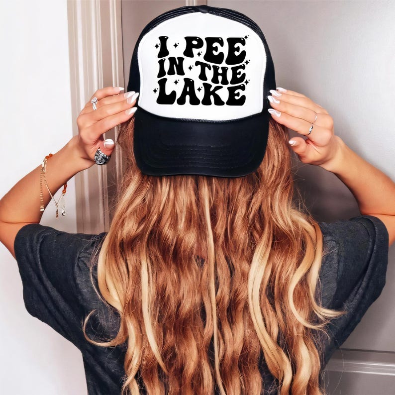 a woman wearing a hat that says i see in the lake