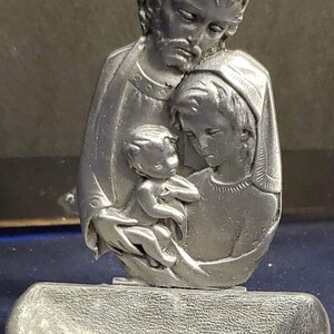 Vintage pewter mother of pearl and holy family pendant.