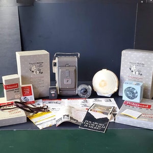 Vintage Polaroid land camera, model 80, in original box and comes with ALL ACCESSORIES! All in original box Vintage brand new mint condition