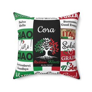May include: Square decorative pillow with a patchwork design featuring Italian phrases and imagery. The pillow has a black center with a tree graphic and the words "Cora" and "Italian Roots". Green, white, and red accents.