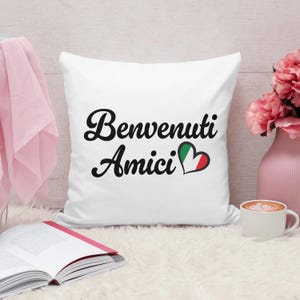 May include: White pillow with black text that says "Benvenuti Amici" with a heart shaped Italian flag.