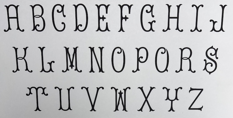 May include: A black and white alphabet with decorative flourishes. The letters are in a traditional font style.