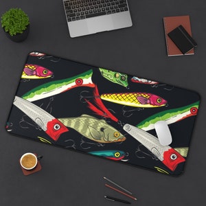 May include: A black mouse pad with a colorful design of fishing lures. The lures are in various colors, including red, green, yellow, and blue. The design is repeated across the mouse pad.