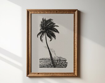 May include: A black and white illustration of a palm tree on a beach. The palm tree is in the centre of the image and is surrounded by sand and water. The image is framed in a brown wooden frame.