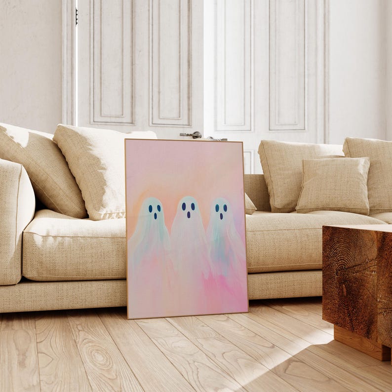 May include: Three white ghosts with blue eyes on a pink and orange background. The ghosts are in a row and are slightly transparent. The background is a watercolor wash.