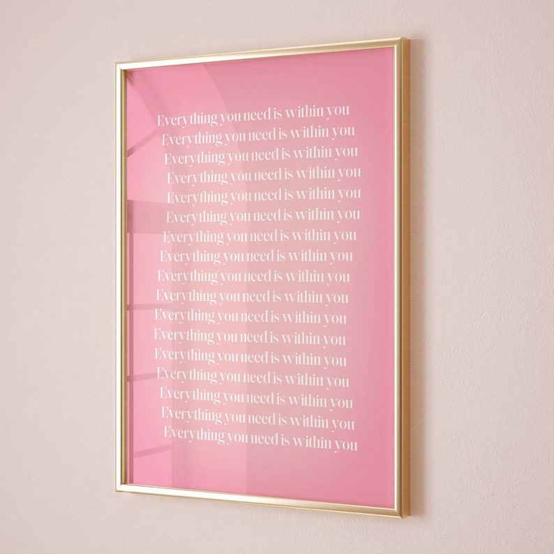 Puede incluir: Una impresi&oacute;n enmarcada rosa con el texto "Everything you need is within you" repetido 17 veces en blanco.