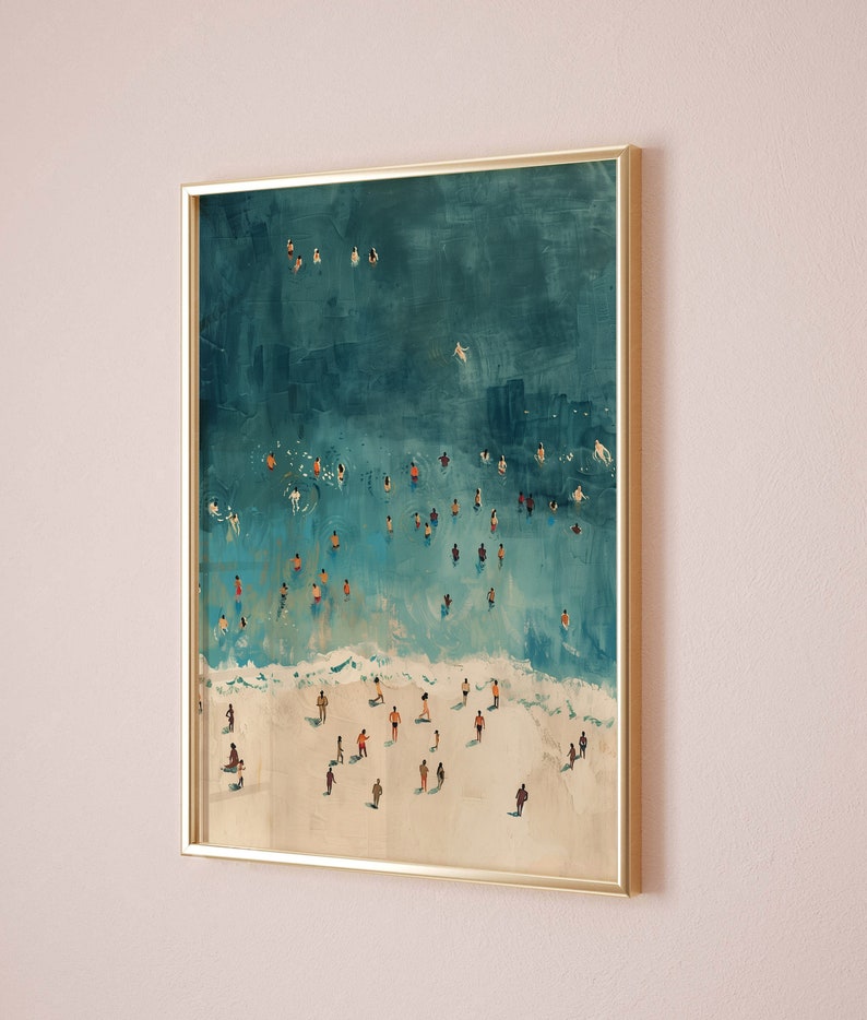 May include: A framed painting of an aerial view of a beach with people swimming and sunbathing in the turquoise water. The beach is white sand and the water is a vibrant blue.