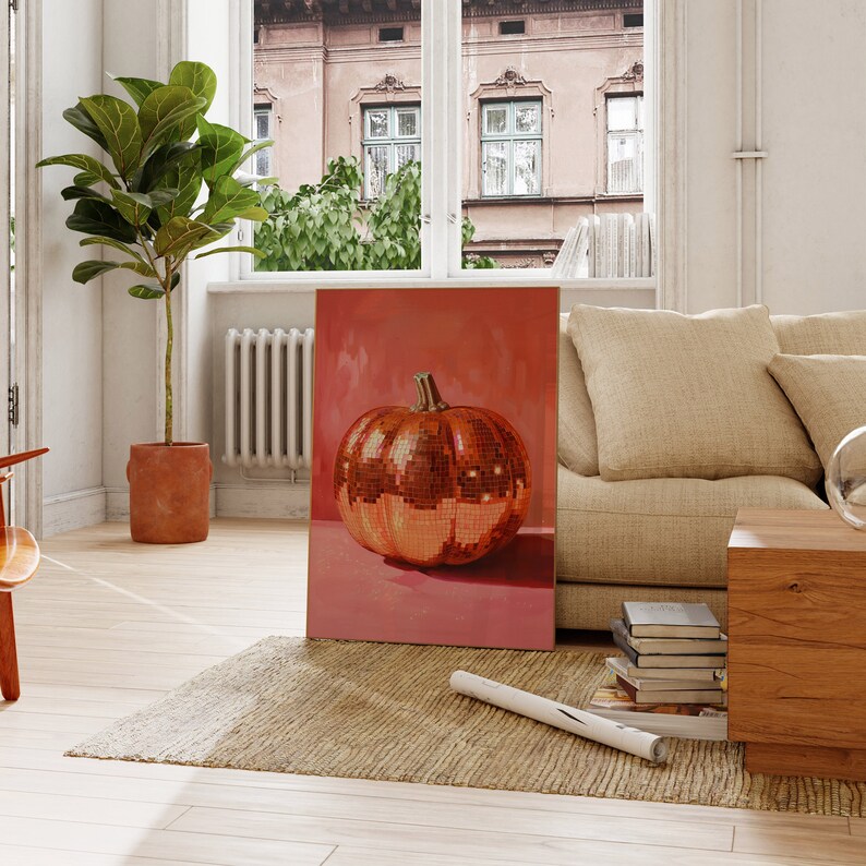 Pu&ograve; includere: Un dipinto incorniciato di una zucca a forma di palla da disco dorata su sfondo rosa.