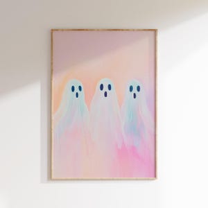 May include: A digital art print featuring three pastel-colored ghosts with blue eyes on a pink background.