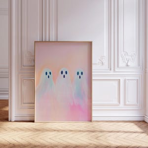 May include: Three white ghosts with blue eyes on a pink and orange background. The ghosts are in a row and are slightly overlapping. The background is a gradient of pink and orange.
