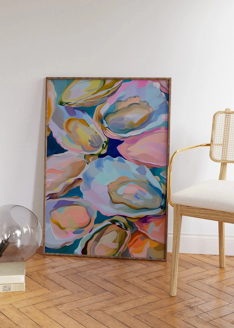 May include: Abstract painting of colorful oyster shells in shades of pink, blue, green, and yellow. The painting is framed in a natural wood frame.