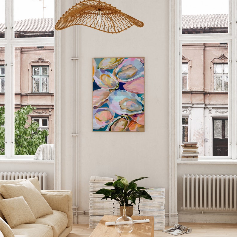 May include: Abstract painting of oyster shells in shades of pink, blue, and green. The painting is framed and hanging on a white wall.