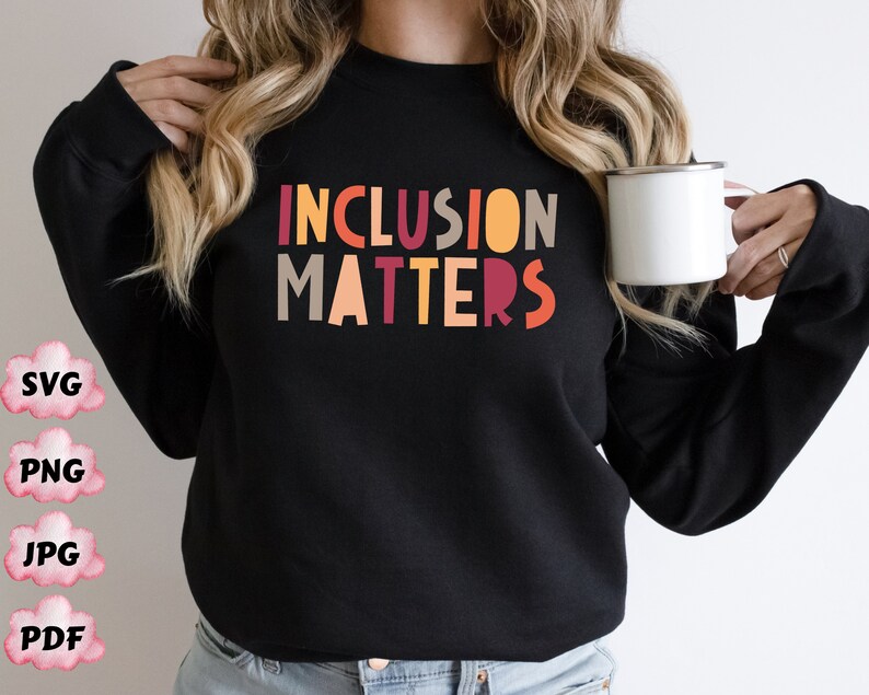 May include: A black sweatshirt with the text "INCLUSION MATTERS" in colorful block letters. The letters are in shades of orange, red, yellow, and brown.