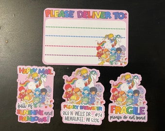 May include: Three pink and white stickers with a rainbow unicorn and a group of cartoon characters. The first sticker says "Happy Mail full of Sunshine and Rainbows!" The second sticker says "Punky Brewster 8168 N. Wells Dr., #24 Milwaukee, WI 53216". The third sticker says "Fragile please do not bend".