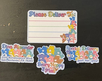 May include: A set of four colorful stickers featuring Care Bears characters. The stickers are for a special delivery and include a "Please Deliver To" address label, a "Beary Happy Mail" label, a "Special Delivery" label, and a label with the text "Dina Alexander, 2519 Renaissance Blvd, San Antonio, TX 78203".