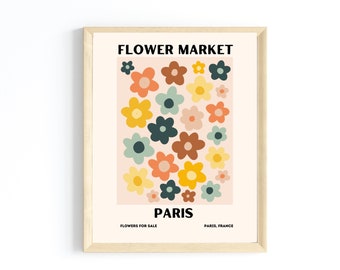 May include: A framed print with a retro design featuring a colorful floral pattern and the text "FLOWER MARKET PARIS" with the words "FLOWERS FOR SALE PARIS, FRANCE" at the bottom.