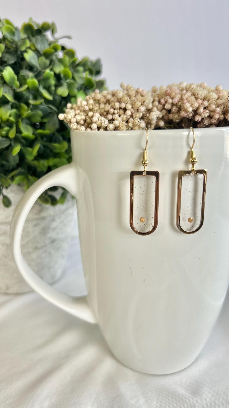Gold Window Earrings Mustard Seed Design Faith Jewelry Collection Christian Gift Idea Handmade Resin Creation Biblical Symbol Representation Hope Inspiration Message Spiritual Present Valentine Day Gift Lightweight Dangle Style Religious