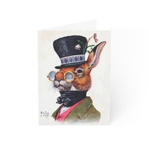 Puede incluir: Tarjeta de felicitación con una ilustración de un conejo elegante. El conejo lleva un sombrero de copa negro, gafas redondas, un pañuelo negro y una chaqueta verde sobre un chaleco rosa. La obra de arte tiene un estilo vintage y caprichoso.