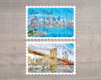 May include: Two postage stamp-style prints featuring watercolor illustrations of New York City landmarks. The top stamp shows the city skyline and the Brooklyn Bridge. The bottom stamp depicts the Brooklyn Bridge with the city skyline in the background. Both stamps have the text "New York".