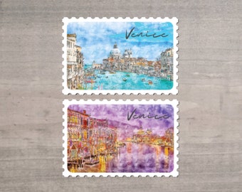 May include: Two postage stamp-shaped stickers featuring watercolor paintings of Venice. One shows a blue sky and turquoise water with buildings. The other depicts a purple and orange cityscape. Both have the word "Venice" in script.
