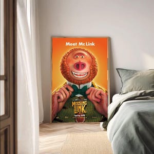 May include: A framed movie poster for "Missing Link" featuring a cartoon character with orange fur, a green bow tie, and the text "Meet Mr. Link." The poster has a warm color palette with an orange background.