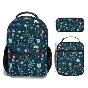 May include: A blue backpack, lunch bag, and pencil case with a floral pattern. The pattern features flowers, leaves, stars, and ladybugs on a dark blue background.