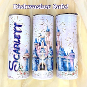 May include: Three white tumblers with a castle design, fireworks, and floral accents. One tumbler has the name "Scarlett" in blue script. The tumblers have a silver rim and the text "Dishwasher Safe!"
