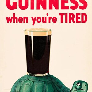 May include: Vintage advertisement featuring a pint of Guinness stout atop a green turtle. The text in red reads "Have a Guinness when you're TIRED". The image has a retro, illustrative style.