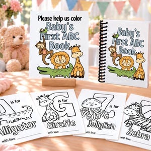 May include: A set of Baby's First ABC Book coloring pages and a spiral-bound book featuring illustrations of a monkey, lion, giraffe, and alligator. Individual sheets show letters A, G, J, and Z with animal drawings and the text 'is for'.