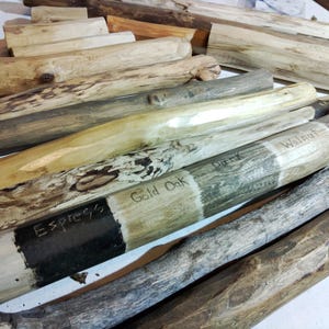 May include: Close-up of wooden samples stained in various shades of brown, including Espresso, Gold Oak, Dark, and Walnut. The wood samples are arranged in a fan shape, with the darkest stain at the bottom and the lightest stain at the top.