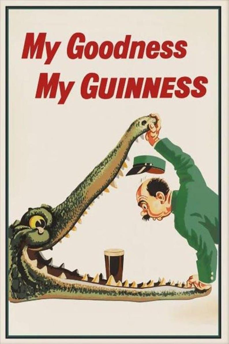 May include: Vintage Guinness advertisement featuring a cartoon alligator with a man in a green suit. The alligator's mouth holds a pint of Guinness. The text "My Goodness My Guinness" is in red.