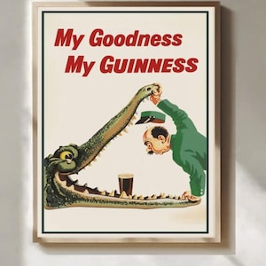 May include: Framed vintage advertisement with the text "My Goodness My Guinness." The image depicts a man in a green suit and a crocodile with a pint of Guinness in its mouth. The poster has a cream background.