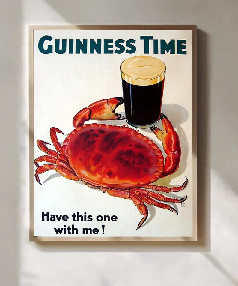 May include: A framed print featuring a pint of Guinness stout held by a red crab. The text "Guinness Time" is at the top, with "Have this one with me!" at the bottom. The artwork has a vintage, illustrative style.