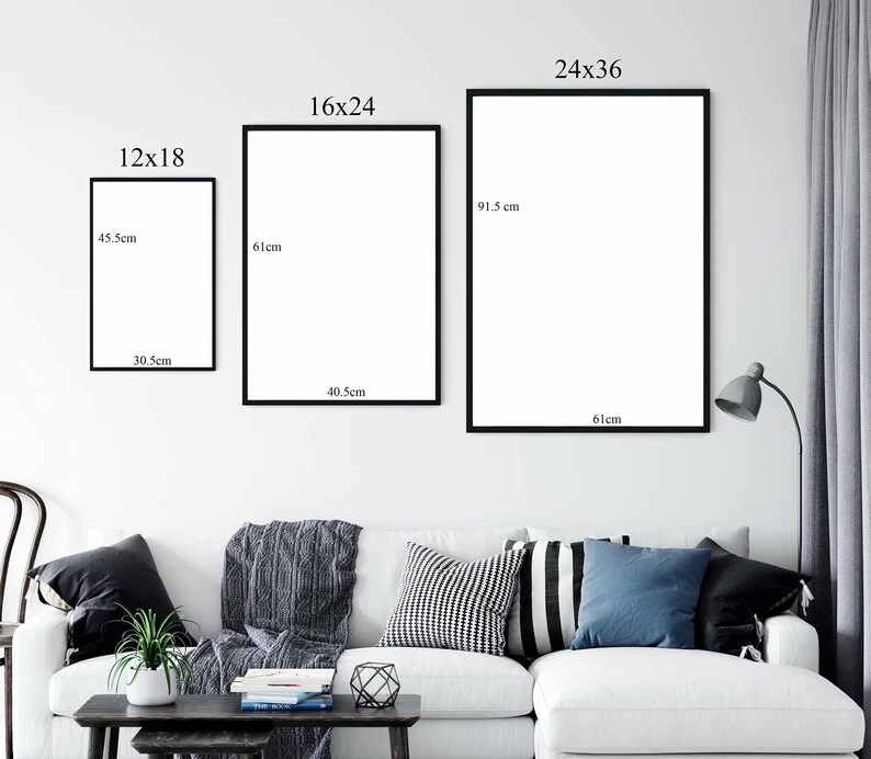 May include: Three framed art prints of varying sizes are displayed on a white wall. The prints are in black frames. The smallest print measures 30.5cm x 45.5cm, the medium print is 40.5cm x 61cm, and the largest is 61cm x 91.5cm. A sofa is below.